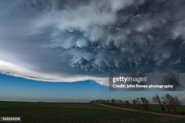 mammatus clouds under thunderstorm - mammatus cloud stock pictures, royalty-free photos & images