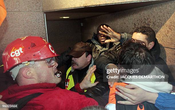 Employees of French oil giant Total storm on February 1, 2010 the tower of Total in La Defense near Paris, to protest against the closure of Dunkirk...