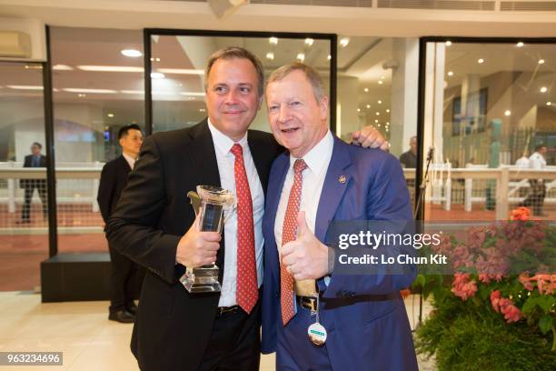 Southern Legend's trainer Caspar Fownes and HKJC’s Chief Executive Officer Winfried Engelbrecht-Bresges celebrate after winning the Kranji Mile at...