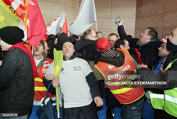 Employees of French oil giant Total storm on February 1, 2010 the tower of Total in La Defense near Paris, to protest against the closure of Dunkirk...