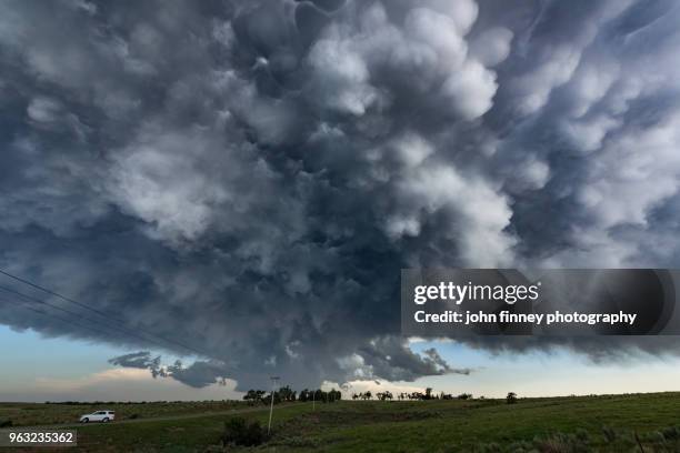 exploding mammatus clouds under thunderstorm - mammatus cloud stock pictures, royalty-free photos & images