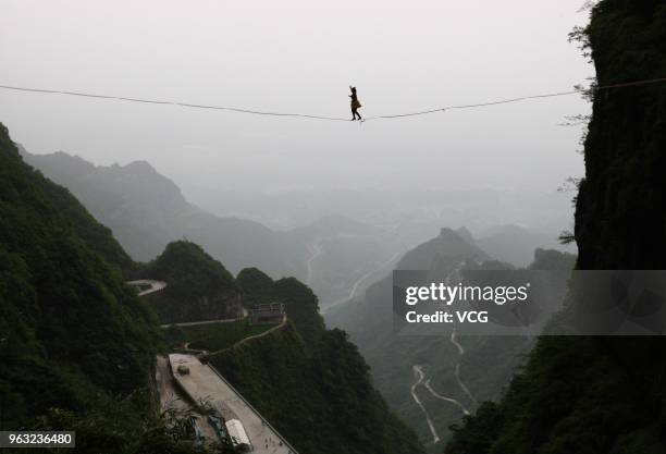 Canadian slackliner Mia Noblet walks on a slackline during 'Tianmen Mountain Female High-Heeled Highline Challenge' at Zhangjiajie National Forest...