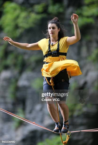 Canadian slackliner Mia Noblet walks on a slackline during 'Tianmen Mountain Female High-Heeled Highline Challenge' at Zhangjiajie National Forest...