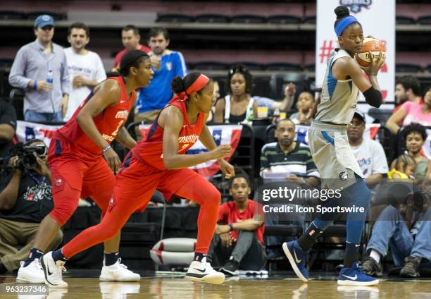 Washington Mystics forward Myisha Hines-Allen and guard Ariel Atkins watch Minnesota Lynx forward Temi Fagbenle during a WNBA game between the...