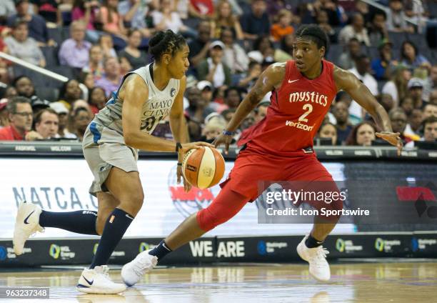 Washington Mystics forward Myisha Hines-Allen keeps an eye on Minnesota Lynx guard Tanisha Wright during a WNBA game between the Washington Mystics...