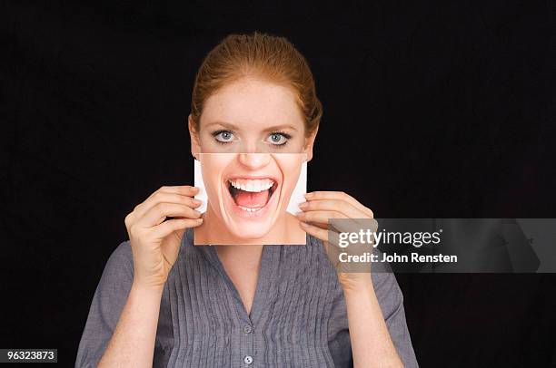 girl hiding behind  mask with happy shouting face - imitation stock-fotos und bilder