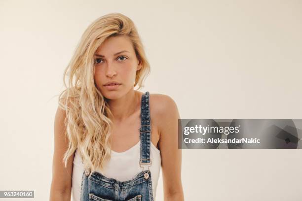 portrait of a cute blonde girl wearing overalls - bib overalls stock pictures, royalty-free photos & images