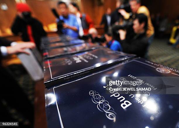 Members of the press take pictures of copies of US President Obama's FY2011 Budget at the Dirksen Senate Office Building in Washington, DC, on...