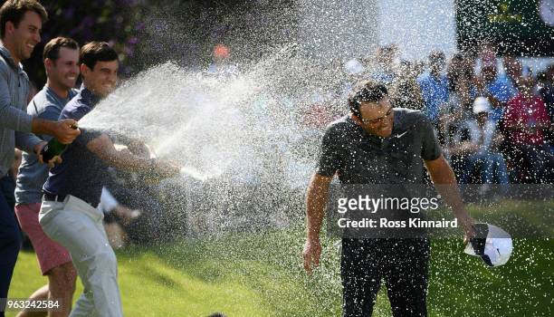 Francesco Molinari of Italy is sprayed with champagne after victory in the final round of the BMW PGA Championship at Wentworth on May 27, 2018 in...
