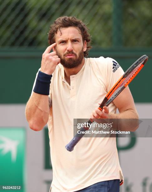 Ernests Gulbis of Latvia reacts during the mens singles first round match against Gilles Muller of Luxembourg during day two of the 2018 French Open...