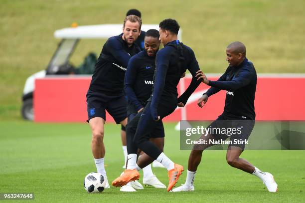 Harry Kane, Raheem Sterling, Jesse Lingard and Ashley Young in action during a training session at St Georges Park on May 28, 2018 in...