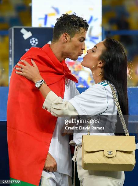 Cristiano Ronaldo of Real Madrid CF kisses hsi girlfriend Georgina Rodriguez as they celebrate his side victory following winning the UEFA Champions...