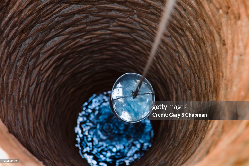 Water bucket being raised from a well