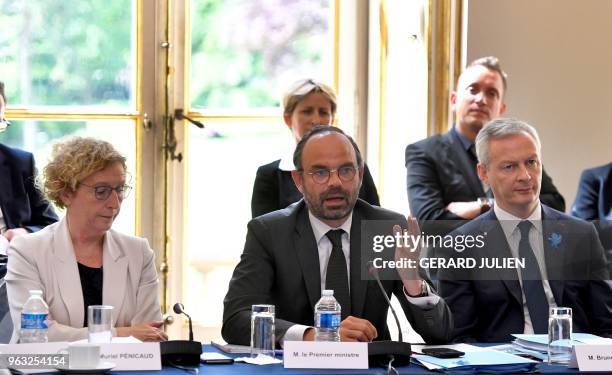 French Prime Minister Edouard Philippe , flanked by French Labour Minister Muriel Pénicaud and French Finance Minister Bruno Le Maire , presents the...