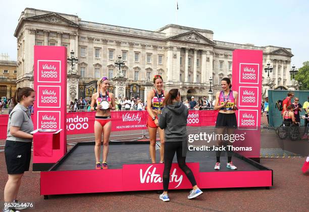 Retired British track and field athlete Jessica Ennis-Hill presents womens winner Steph Twell with the winner trophy during the Vitality London...