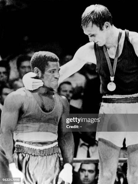 Manfred Wolke from East Germany hugs Joseph Bessala from Cameroon on the podium after winning the summer Olympics boxing Final Welterweight, on...