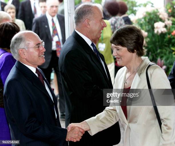 Australian Prime Minister John Howard welcomes his New Zealand counterpart Helen Clark as Commonwealth Secretary General Don McKinnon prepares to...