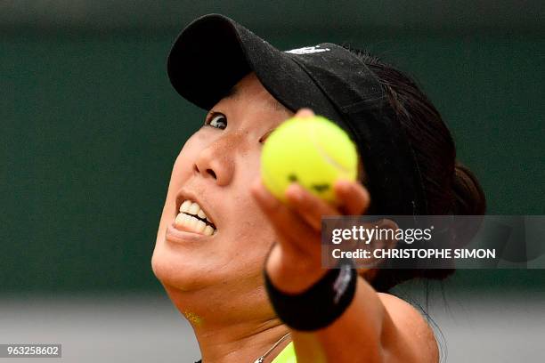 Vania King of the US eyes the ball as she serves to Romania's Mihaela Buzarnescu during their women's singles first round match on day two of The...