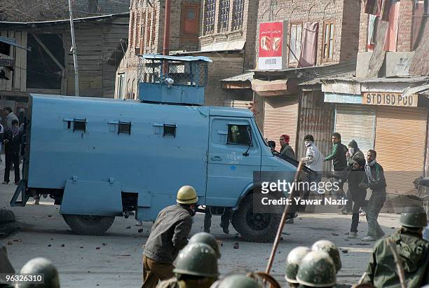Kashmiri protesters chase and throw stones at Indian police during a protest against the death of a 14 years old teenager, Wamiq Farooq on February...