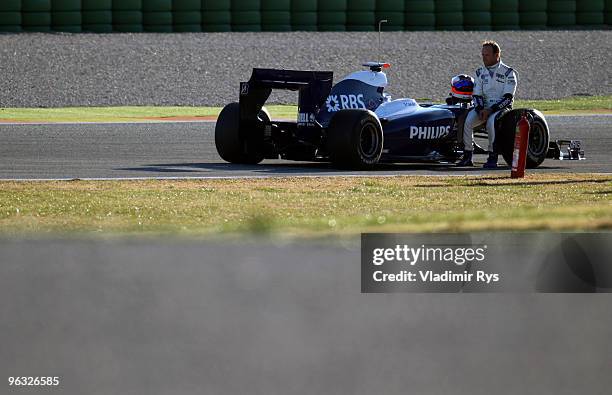 Rubens Barrichello of Brazil and Williams sits on his car after it broke down at the Ricardo Tormo Circuit on February 1, 2010 in Valencia, Spain.