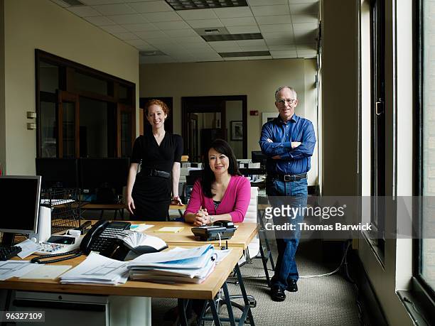three coworkers in office - leanintogether stock pictures, royalty-free photos & images