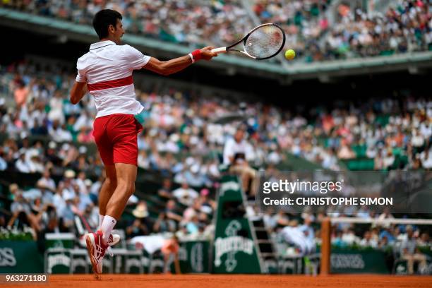 Serbia's Novak Djokovic plays a return to Brazil's Rogerio Dutra Silva during their men's singles first round match on day two of The Roland Garros...