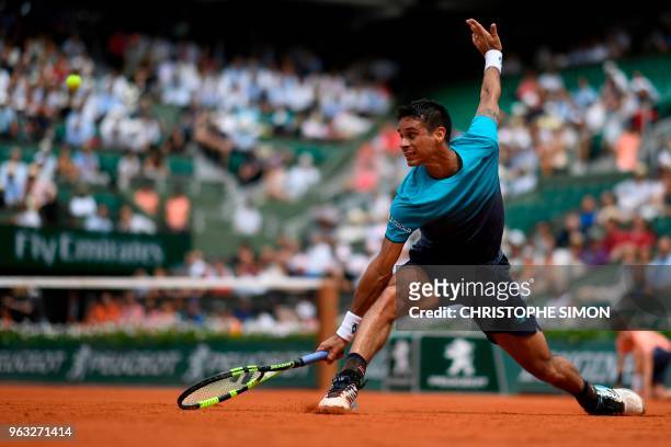 Brazil's Rogerio Dutra Silva plays a return to Serbia's Novak Djokovic during their men's singles first round match on day two of The Roland Garros...