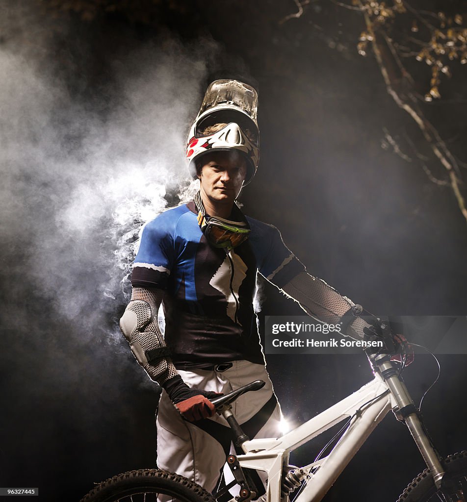 Adult male mountain biker having a rest