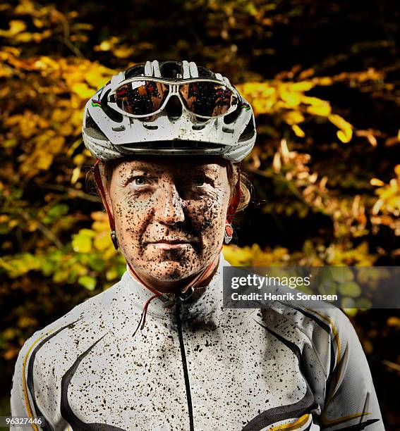 female mountain biker with mud on face - grittywomantrend stock pictures, royalty-free photos & images