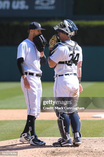 Shane Greene and James McCann of the Detroit Tigers talk together on the pitchers mound during game one of a doubleheader against the Kansas City...