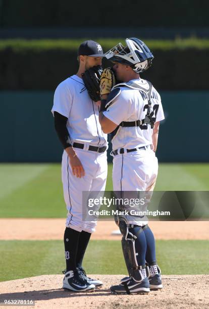 Shane Greene and James McCann of the Detroit Tigers talk together on the pitchers mound during game one of a doubleheader against the Kansas City...
