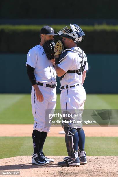 Shane Greene and James McCann of the Detroit Tigers talk together on the pitchers mound during game one of a doubleheader against the Kansas City...