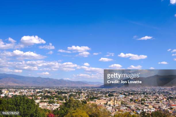 high view of skyline of oaxaca city with surrounding mountains and santo domingo church - santo domingo church stock pictures, royalty-free photos & images
