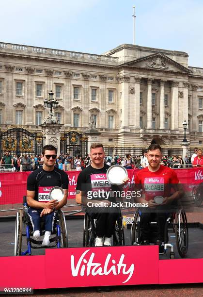 First place David Weir, second place Danny Sidbury and third place Michael Mccabe pose with their trophies during the Vitality London 10,000 on May...