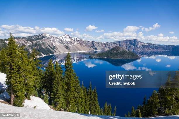 crater lake in springtime with snow - wizard island stock pictures, royalty-free photos & images