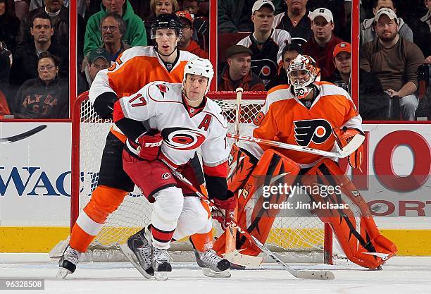 Rod Brind'Amour of the Carolina Hurricanes skates against Braydon Coburn and Ray Emery of the Philadelphia Flyers on January 23, 2010 at Wachovia...