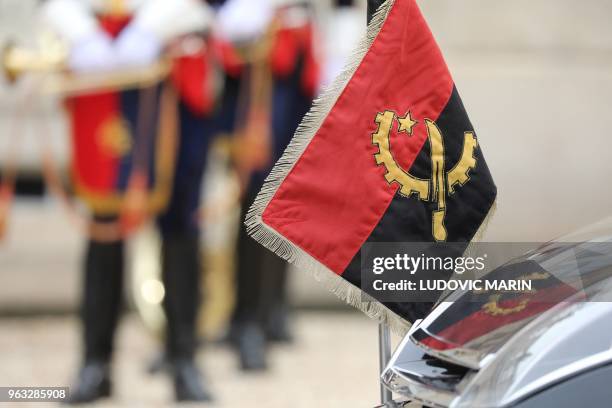 Angola's flag is pictured on the official car of Angolan president in the courtyard of the Elysee presidential palace on May 28, 2018 in Paris.