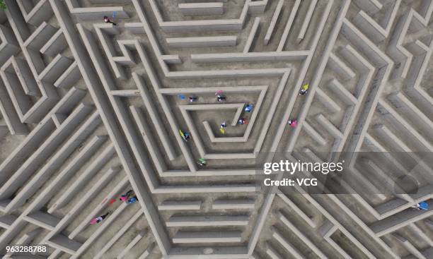 Aerial view of tourists finding their way out of a maze featuring eight-diagram pattern during the 9th Linyi Zhuge Liang Cultural Tourism Festival at...