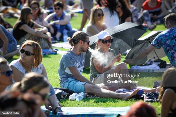 People are seen attending one of the regular, free Chopin open air concerts in the Royal Baths park in Warsaw, Poland on May 27, 2018. During the...