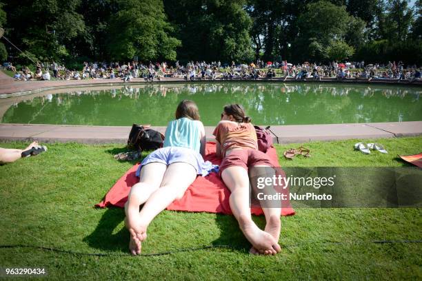 People are seen attending one of the regular, free Chopin open air concerts in the Royal Baths park in Warsaw, Poland on May 27, 2018. During the...