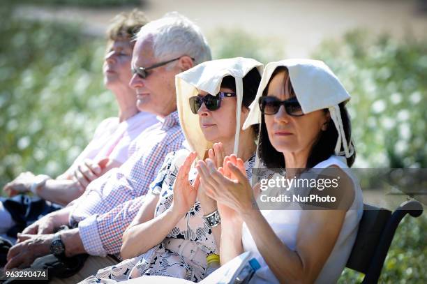 People are seen attending one of the regular, free Chopin open air concerts in the Royal Baths park in Warsaw, Poland on May 27, 2018. During the...