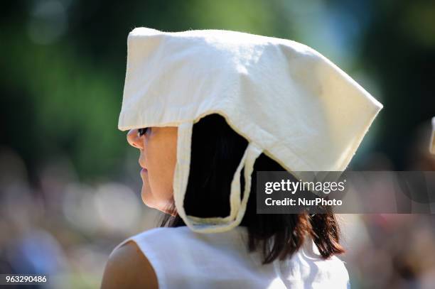 People are seen attending one of the regular, free Chopin open air concerts in the Royal Baths park in Warsaw, Poland on May 27, 2018. During the...