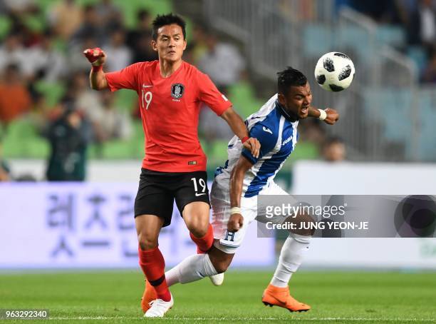South Korea's Hong Chul fights for the ball with Honduras' Mario Martinez during a friendly football match between South Korea and Honduras in Deagu...