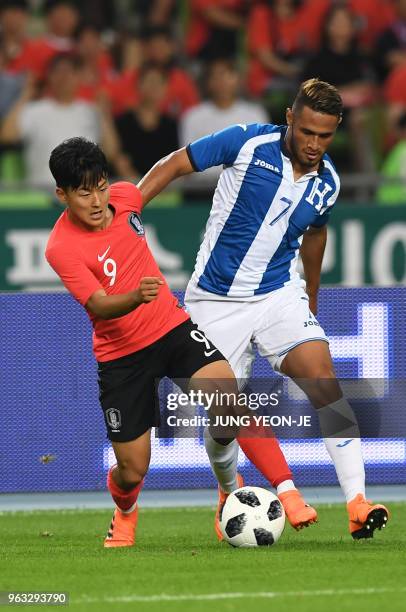 South Korea's Lee Seung-woo fights for the ball with Honduras' Alexander Lopez during a friendly football match between South Korea and Honduras in...