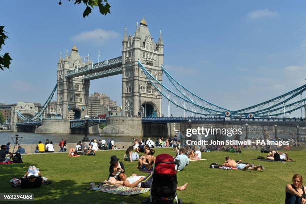 People enjoy the hot weather at Potters Field Park, London, as Britons could see the hottest day of the year this Bank Holiday Monday.