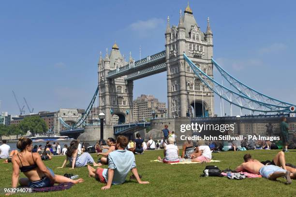People enjoy the hot weather at Potters Field Park, London, as Britons could see the hottest day of the year this Bank Holiday Monday.