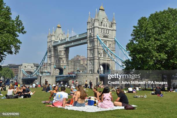 People enjoy the hot weather at Potters Field Park, London, as Britons could see the hottest day of the year this Bank Holiday Monday.