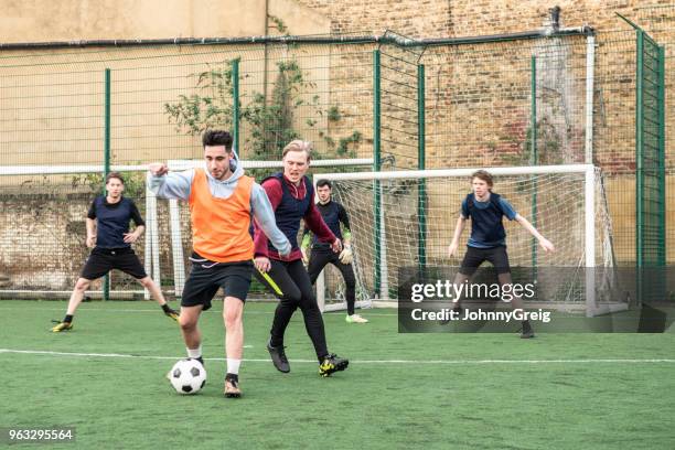 action shot of five football players playing on an outdoor pitch - amateur stock pictures, royalty-free photos & images