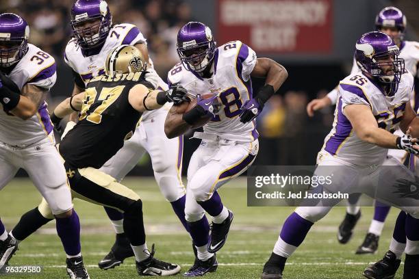 Adrian Peterson of the Minnesota Vikings runs the ball against the New Orleans Saints during the NFC Championship Game at the Louisiana Superdome on...