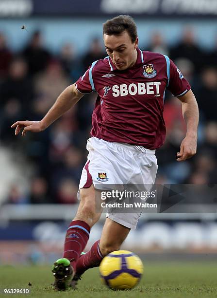 Mark Noble of West Ham United passes the ball during the Barclays Premier League match between West Ham United and Blackburn Rovers at Upton Park on...